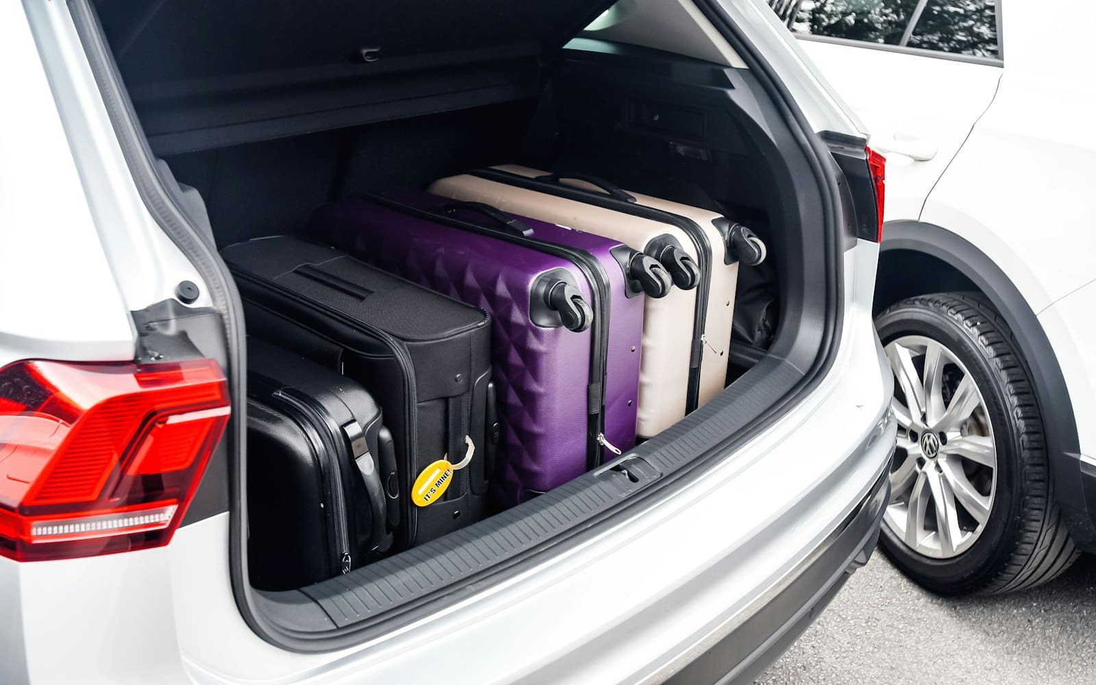 Suitcase packed in the trunk of a car
